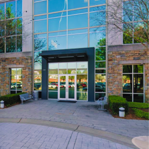 Front entrance of BBCM, PC office building with glass facade and double doors in Montgomery Alabama