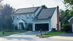 A modern residential home in Abingdon, Virginia, featuring a sleek solar panel installation by Cosmo Solaris. The image highlights the integration of renewable energy infrastructure within the Appalachian Highlands landscape to combat rising energy costs.