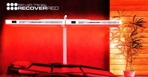 Full body red light therapy device in a modern red glowing room.
