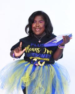 Precious C. Scott-Fields of Precious Kreations Inc. is smiling and posing