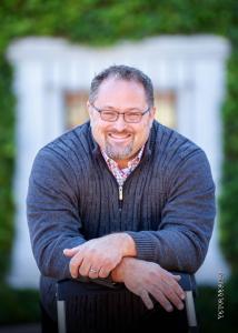 Professional headshot of Ron Hollingsworth, an Arizona real estate expert and Navy veteran specializing in military family relocations.