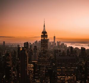 New York City skyline at sunset with silhouette buildings
