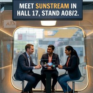 Three professionals in business attire sit around a high table in a modern, glass-walled meeting pod at a trade show. A digital sign above them reads "Meet Sunstream in Hall 17, Stand A08/2." The atmosphere is friendly and collaborative.