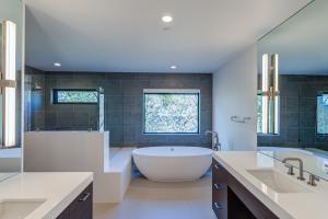 A beautiful master bathroom with pedestal soaking tub walk in shower and dual vanities