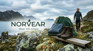 Norvear hiking boots and outdoor apparel displayed in a Nordic coastal landscape with mountains and sea in the background