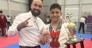 Eli Cooper with promoter Jonathan Milot holding trophy and medals after winning Grand Champion title in Montreal