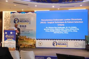 Dr Mohana Rao Patibandla presenting on percutaneous endoscopic lumbar discectomy at Neuroendocon 2026 conference in Jaipur