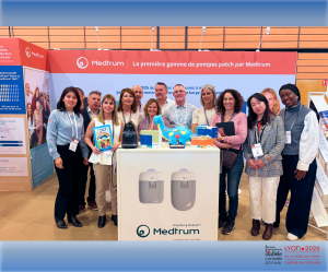 Medtrum staff at booth showcasing TouchCare patch pump device.