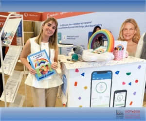 Diabetes advocate Elisa Robache holds her book “C’est quoi le diabète?” while standing with the Medtrum team at the SFD 2026 congress booth in Lyon.