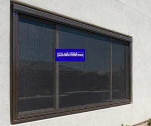 Motorized window shades automatically lowering over large windows in a Henderson home, showcasing modern smart blinds and automated blinds Las Vegas.