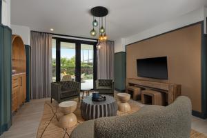 a living room with modern furniture looking out onto a patio