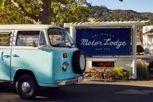 VW van in front of lighted motel sign