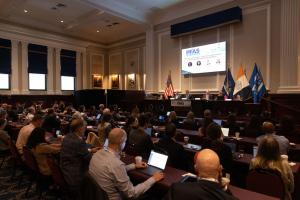 A large room at the New York Bar Association filled with conference delegates listening to a panel discussion on the podium at the Summit on PFAS Regulation, Compliance, and Litigation