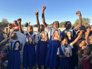 Students of Kapiri Primary School in Mzimba cheering at new well installation