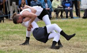 2 men wrestling according to Cumberland & Westmorland Association rules in traditional costume