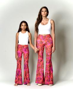 Mother and daughter wearing matching pink butterfly print luxury bohemian bell bottoms from the Bougie Hippie Mini and Me collection