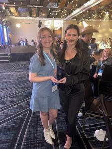 Leaders Kelsey and Julie holding the APC Top Workplaces Award