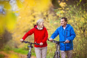Active adults riding bikes outdoors, enjoying movement with osteoarthritis