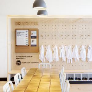 Birkenstock branded wall at Little Kitchen Academy with Birkenstock chef shoes and chef coats