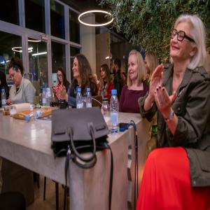 Women attending a healthcare workshop, applauding during a wellness session focused on hormonal health, education, and community support in the Middle East.