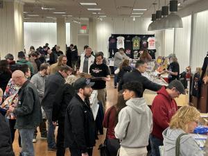 Vinyl diggers searching for records in a crowd