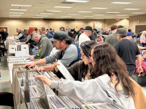 A photo of women shopping for records