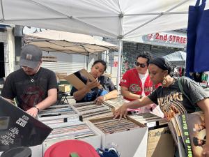 Men look at records at an outdoor market