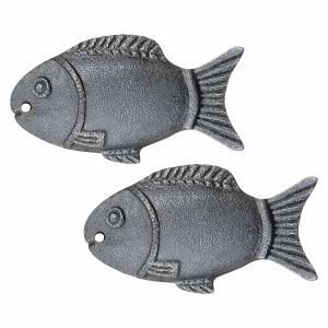 Two cast iron fish shapes used as cooking tools to increase iron content in food naturally