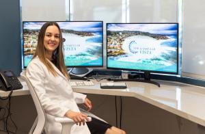 Female physician sitting in front of computer screens