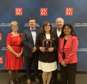 Five individuals from Duperon Corporation and Saginaw Valley State University pose with award.