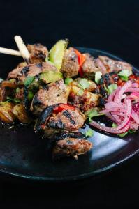 Grilled steak kabobs with peppers and onions, served with Mediterranean crispy grilled potatoes and pickled onions, prepared by Chef Serge Krikorian of Vibrant Occasions Catering.