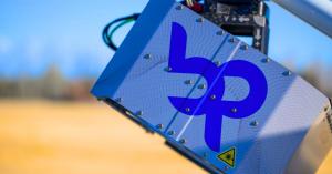 Bridger Photonics Gas Mapping LiDAR sensor attached to the strut of a small aircraft with mountains in the background.