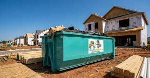 Trash Pandy teal roll-off dumpster between two homes under construction in Tennessee subdivision