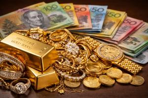 Gold jewellery and bullion bars with Australian dollar cash illustrating gold buying and selling value in Australia