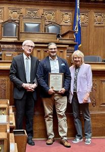 Paul Moga accepting his award with Governor and Mrs. Evers