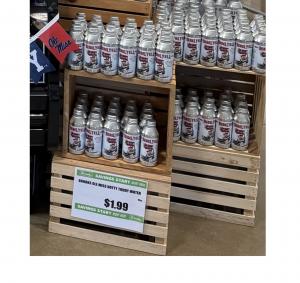 Rebel Yell Spring Water cans displayed on a retail shelf with $1.99 price signage in a Tupelo, Mississippi grocery store