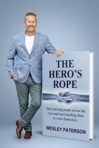 Wesley Paterson standing next to The Hero's Rope Big Book
