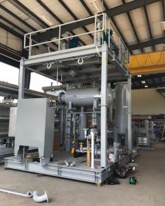 A large, grey industrial skid is positioned in a fabrication shop, displaying the Raw Welding Crane & Rigging logo. It is rigged with heavy metal chains and straps, demonstrating the integrated fabrication and lifting services provided by Raw Welding.