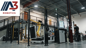 FANUC industrial robot operating inside a safety-enclosed automation cell in a manufacturing facility designed by DEVELOP