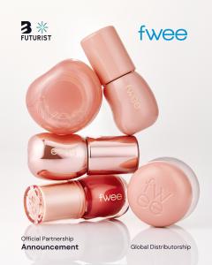 A professional product display of fwee K-beauty cosmetics in soft peach and nude tones, including the iconic pudding pots and lip tints stacked creatively for a Futurist global partnership announcement.