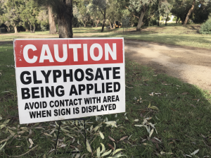 Caution sign stating Glyphosate Being Applied, Avoid Contact with area when Sign is Displayed