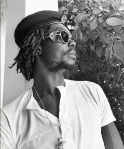 Picture of Peter Tosh in a beret: As a founding member of The Wailers, Peter Tosh launched his solo career and established himself as one of reggae’s most outspoken and influential voices. ©️2026 Kim Goittlieb / Under license by Tosh Holdings LLC