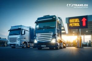 Trucks by a gas station where there is a display who says Diesel Petrol and a narrow up indicating prices are increasing