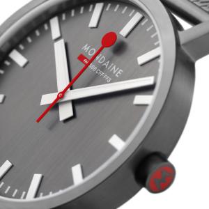 MONDAINE Classic Anthracite watch with a grey dial, iconic red seconds hand, and stainless steel Milanaise mesh bracelet, featuring a minimalist Swiss design.