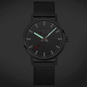 MONDAINE Classic Anthracite watch with a grey dial, iconic red seconds hand, and stainless steel Milanaise mesh bracelet, featuring a minimalist Swiss design.