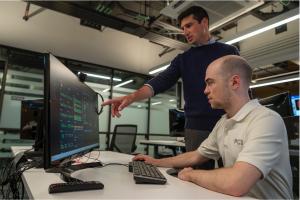 Naval Postgraduate School (NPS) Space Systems Academic Group research associate professor Giovanni Minelli, left, and Ph.D. student Noah Weitz, right, track CubeSat orbital data in NPS' Satellite Operations Center.