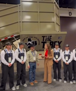 Ag mechanics instructor Dorman Vick and students from Samuel V Champion High School in Boerne Texas stand with U.S. Secretary of Agriculture Brooke Rollins in front of The T-Rex mobile dipping vat built by the students for the USDA cattle fever tick eradi