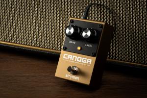 Strymon's Canoga fuzz pedal leaning against the grill cloth of a combo amplifier