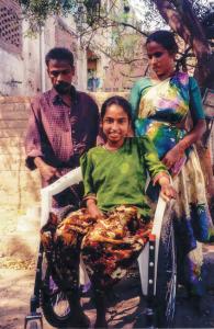 Lotus Blossom, one of the first wheelchair recipients, with her parents in India