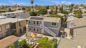 Two-story detached ADU in a San Diego backyard showing completed construction and site integration